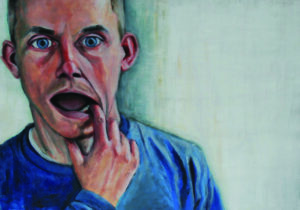 A person using their finger to show their lower left teeth.